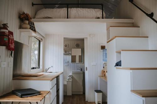 a tiny house with a sink and a bunk bed at Tiny House 11 at Grampians Edge in Dadswells Bridge
