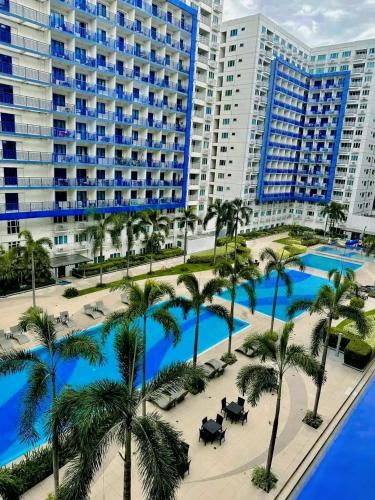 an aerial view of a resort with palm trees and buildings at Benedick Place at sea residences in Manila