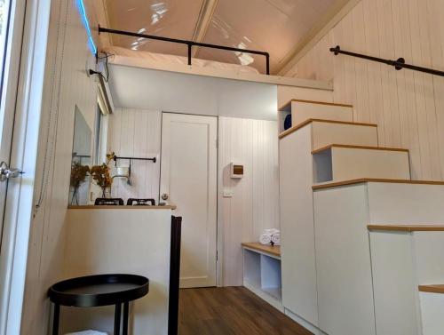 a small room with a table and a stool at Tiny House 20 at Grampians Edge in Dadswells Bridge