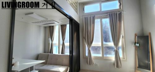 a mirror in a room with a chair and a window at Near DMC, Fully furnished, Loft sturcture, New APT in Goyang