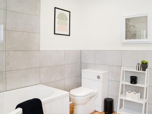 a bathroom with a white toilet and a sink at Main Street Flat A - Uk46448 in Ayr