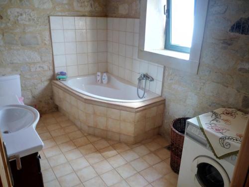 a bathroom with a tub and a sink at Villa Aloni in Margarítai