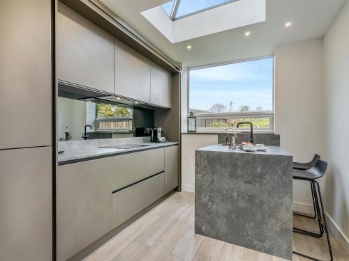 a kitchen with a counter and a sink and a window at Gateway Retreat in Barrowford