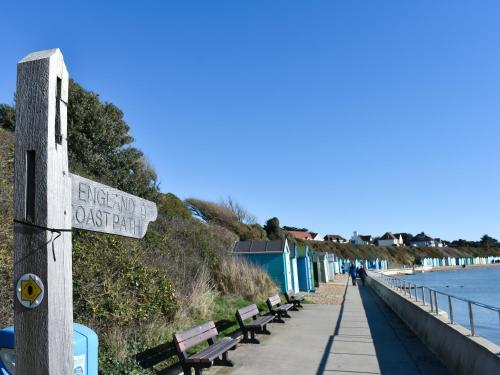 a sign on a boardwalk next to a beach at Oakmere in Fareham