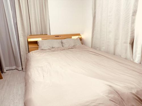 Postel nebo postele na pokoji v ubytování Bon House Kanamachi Direct to Sensoji Skytree Disneyland Airport Free Parking