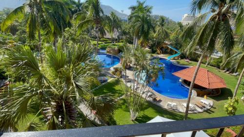an aerial view of a resort pool with palm trees at Sol y Mar. Delfines in Ixtapa
