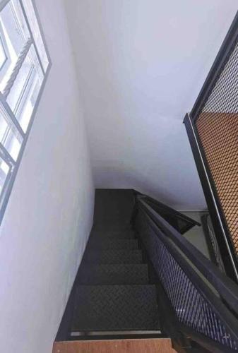 a staircase in a building with a stair case at Nieo Village 1 in Port Dickson