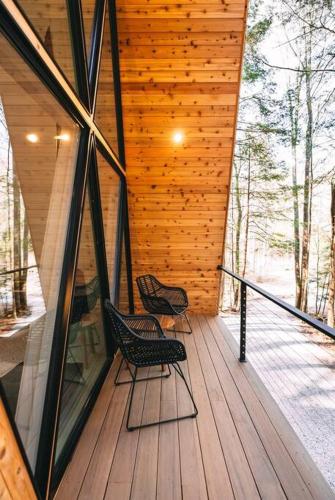 two chairs sitting on a deck in a house at Dunlap Hollow A-Frame in Rockbridge