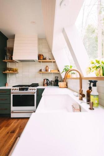 a kitchen with a sink and a stove at Dunlap Hollow A-Frame in Rockbridge