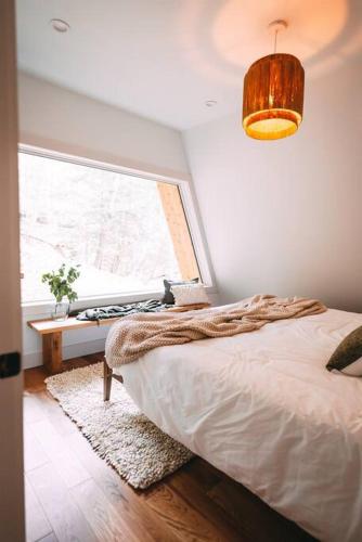 a bedroom with a bed and a window at Dunlap Hollow A-Frame in Rockbridge
