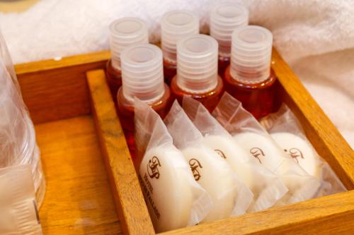 a wooden tray with bottles of honey in a box at Hotel Tempio Di Pallade in Rome