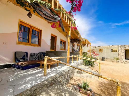 a house with a bed on the side of it at Live the bedouinlife in Nuweiba