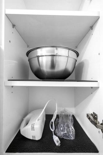 a shelf with a bowl on top of it at Stylish - Water View Condo - Palm Wave Says in Coconut Creek