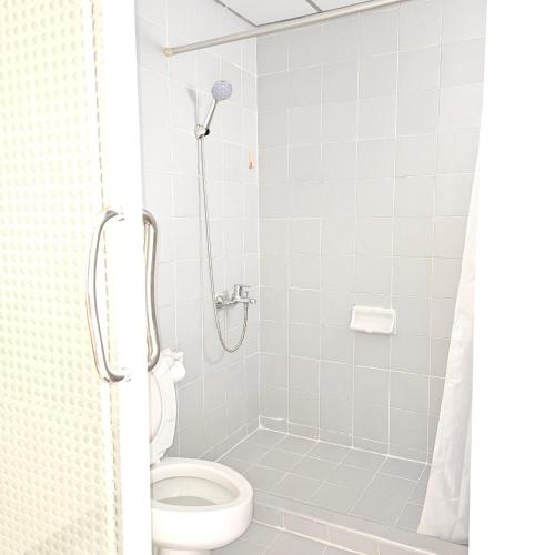 a bathroom with a shower with a toilet at Omni Suites 2Bedroom in Bangkok