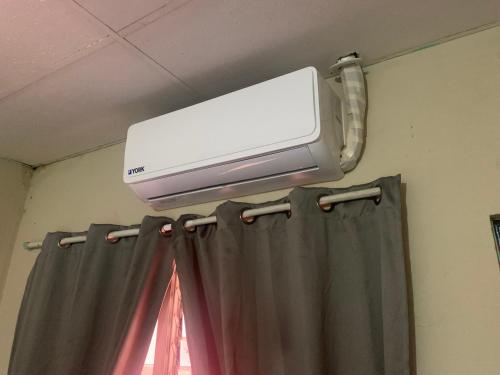 a air conditioner on the ceiling of a room at Estrada House in Santa Ana