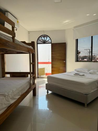 a bedroom with two bunk beds and a window at Hotel Balcones del Sinu in Lorica