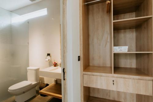 a bathroom with a toilet and a sink at The Pahala Villas in Nusa Dua