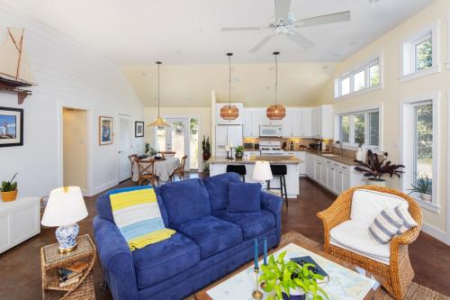 a living room with a blue couch and a kitchen at The Nest at Deep Cove in Chester
