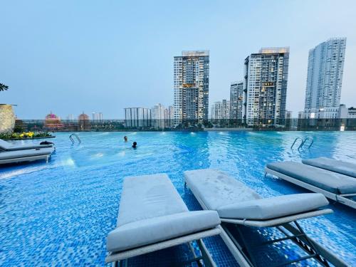 a swimming pool in a city with tall buildings at THE LUMIÈRE RIVERSIDE LUXURY SUITE in Ho Chi Minh City