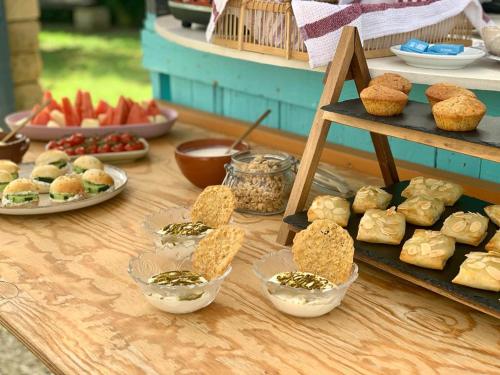 a table topped with different types of pastries in bowls at The Place Yoga Retreat *FREE YOGA CLASS in Pantelleria