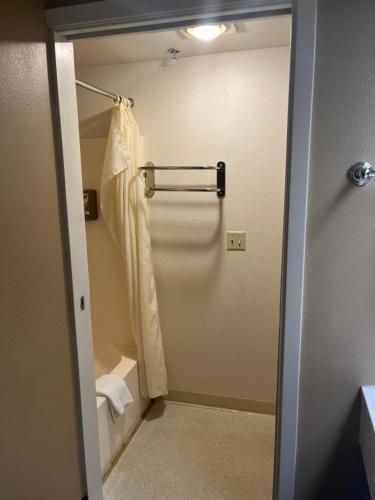 a bathroom with a shower with a shower curtain at Americas Best Value Inn Kalispell in Kalispell