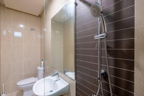 a bathroom with a shower with a toilet and a sink at Bungalow Putrajaya 15pax w Private Pool Gathering in Putrajaya