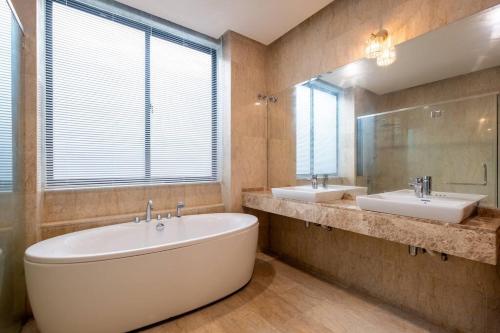 a large bathroom with two sinks and a large mirror at Bungalow Putrajaya 15pax w Private Pool Gathering in Putrajaya