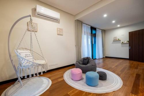 a room with a baby crib and a swing at Bungalow Putrajaya 15pax w Private Pool Gathering in Putrajaya