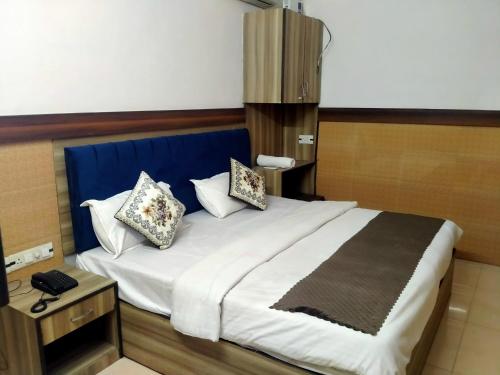 - une chambre avec un grand lit et des oreillers dans l'établissement ANGAD RESIDENCY, à Amritsar