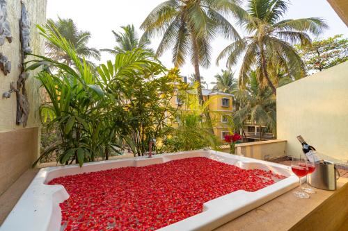 a large tub filled with red peppers on a balcony at Adamo The Bellus Calangute in Calangute