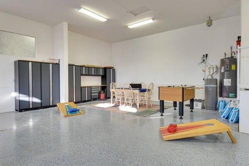 a room with a room with a table and chairs at HavaCabana Pool Spa Games Lake View Garage in Lake Havasu City