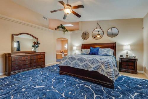 a bedroom with a bed and a dresser and a mirror at HavaCabana Pool Spa Games Lake View Garage in Lake Havasu City