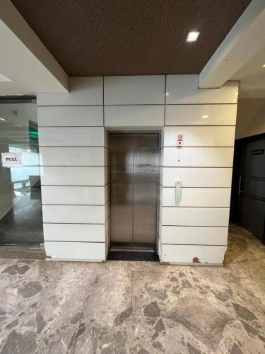 a elevator in a building with a wall at Hotel Shri Radha Nikunj - Opposite Prem Mandir in Vrindāvan