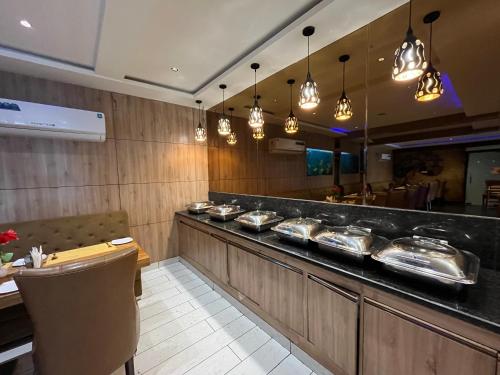 a restaurant with a buffet line with a table at Hotel Shri Radha Nikunj - Opposite Prem Mandir in Vrindāvan