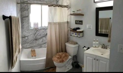 a bathroom with a shower and a toilet and a sink at Creamy, Snug & Delightful Economical Guesthouse in Aurora