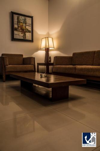 a living room with a couch and a coffee table at Anchorage The Residence in Dhaka