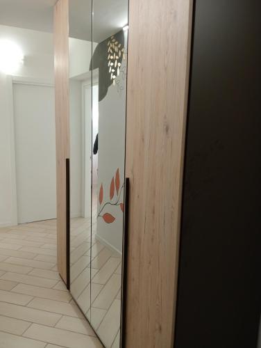 a glass door with a face on it in a hallway at RESIDENZA Giulia e Marco in Cesate