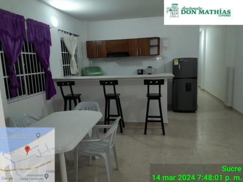 a kitchen with a table and chairs in a room at Apartamentos Don Mathias # 2 in Coveñas