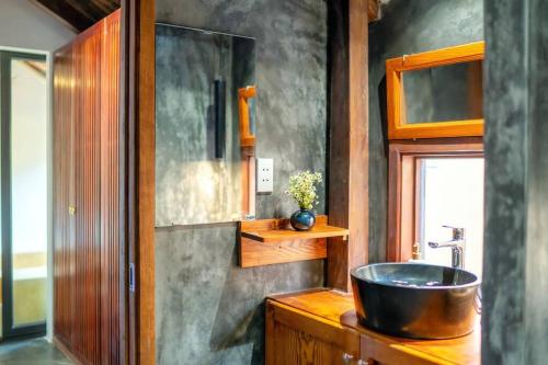 a bathroom with a bowl sink on a wooden counter at Surf Villa in An Bang beach, Hoi An in An Bang