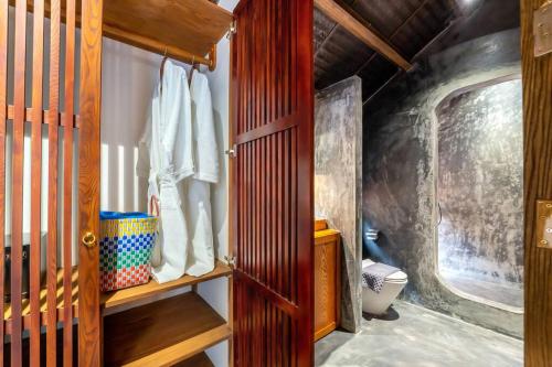 a room with a closet with a wooden door at Surf Villa in An Bang beach, Hoi An in An Bang