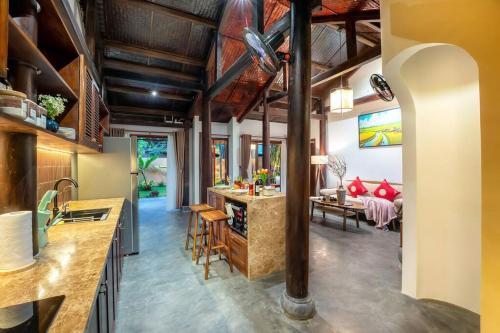 a kitchen and living room with a table and chairs at Surf Villa in An Bang beach, Hoi An in An Bang