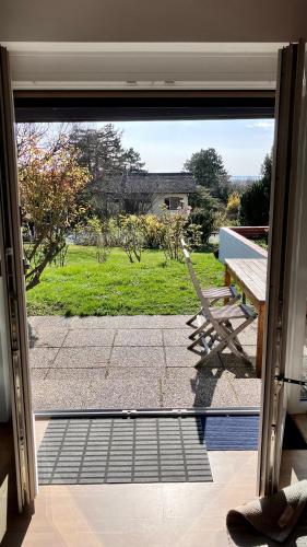 an open door to a patio with a bench outside at Ferienhaus Seeblick in Breitenbrunn
