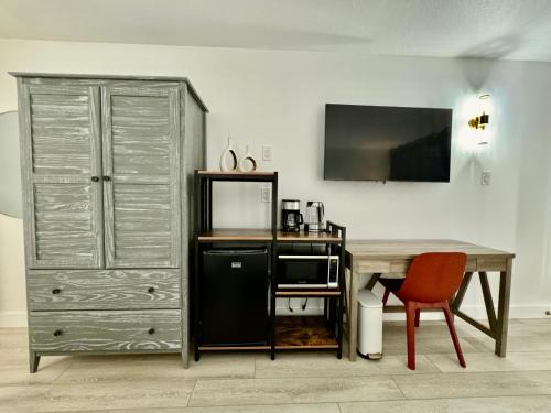 a room with a desk and a dresser and a cabinet at Pool - WiFi - Parking - Best Location ! in Kissimmee