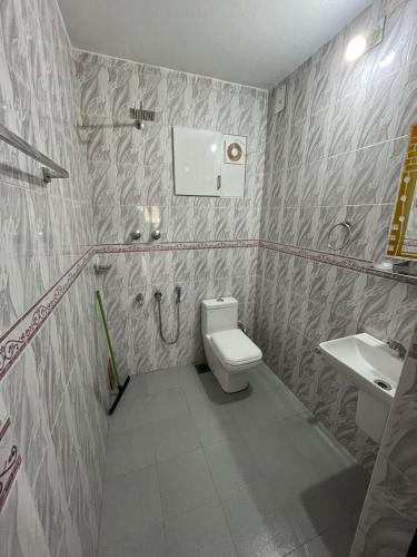 a bathroom with a toilet and a sink at Souparnika Homestay in Kannur