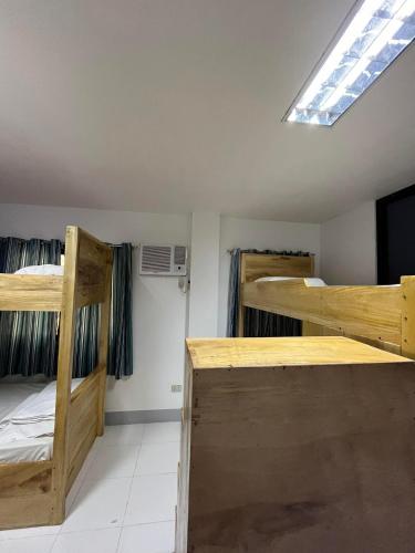 a room with two bunk beds and a skylight at Malaran Guest House in Larena