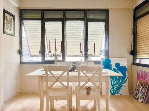 a dining room with a white table and chairs at Cozy House in İzmir