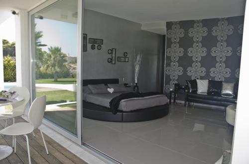 a bedroom with a bed and a sliding glass door at Reveli Estate in Kalathas