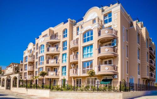 an apartment building with balconies on a street at Apartments Vilma&Villiam in Ravda