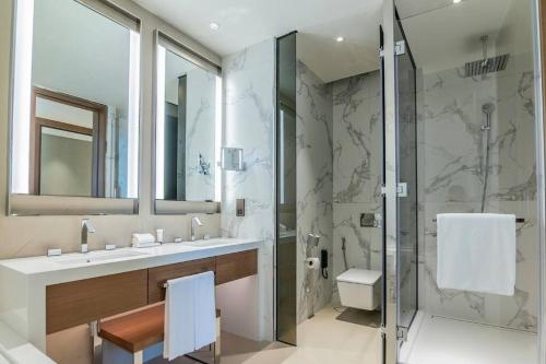 a bathroom with a sink and a shower at 2Bed Dubai Address Opera Residence sea view - Downtown near Burj Khalifa- 5 min walk Dubai mall in Dubai