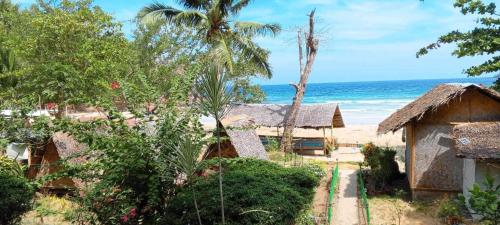 a resort on the beach with the ocean in the background at A&Z Nagtabon Lodge in Bacungan